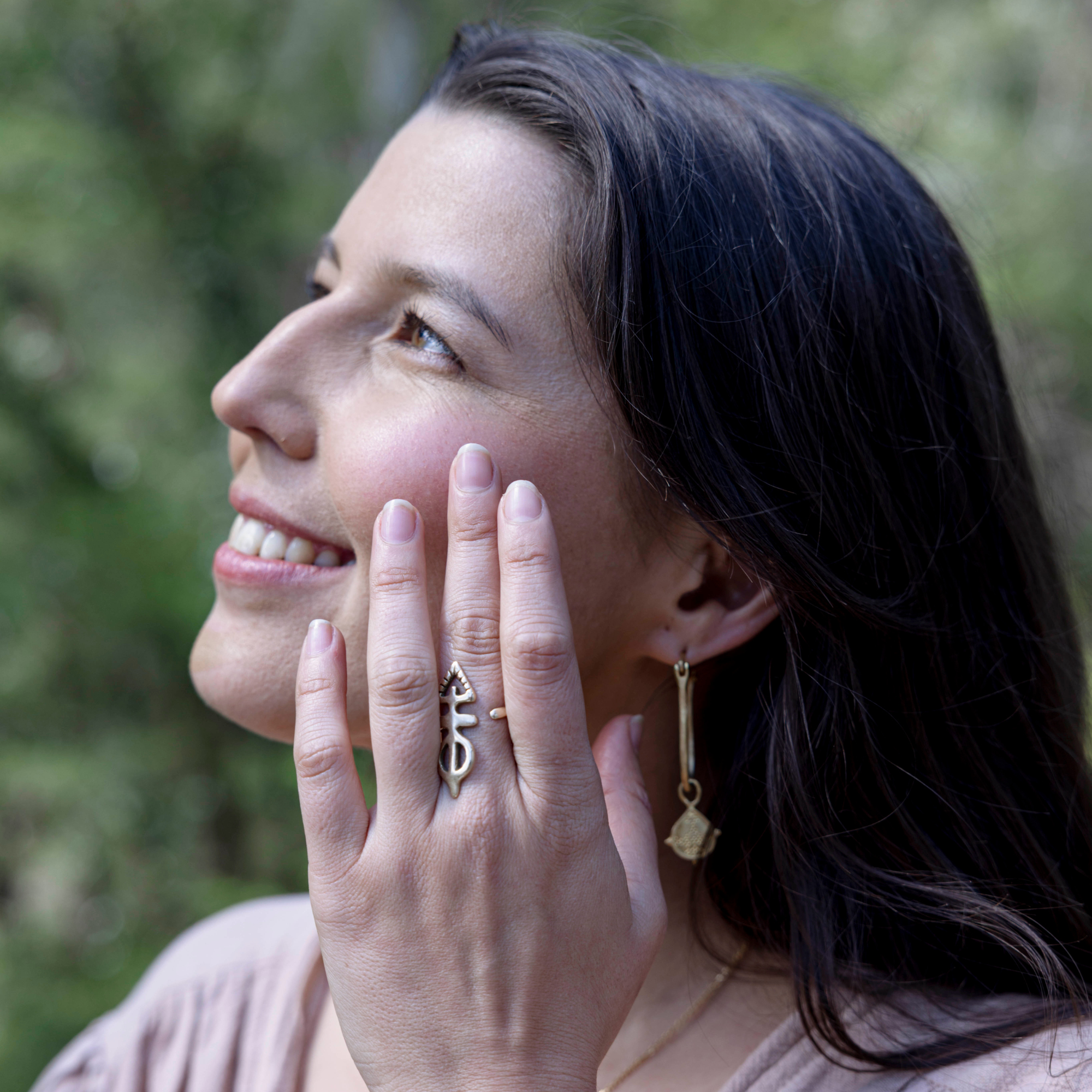 Model using blush tinted cheek and lip creme