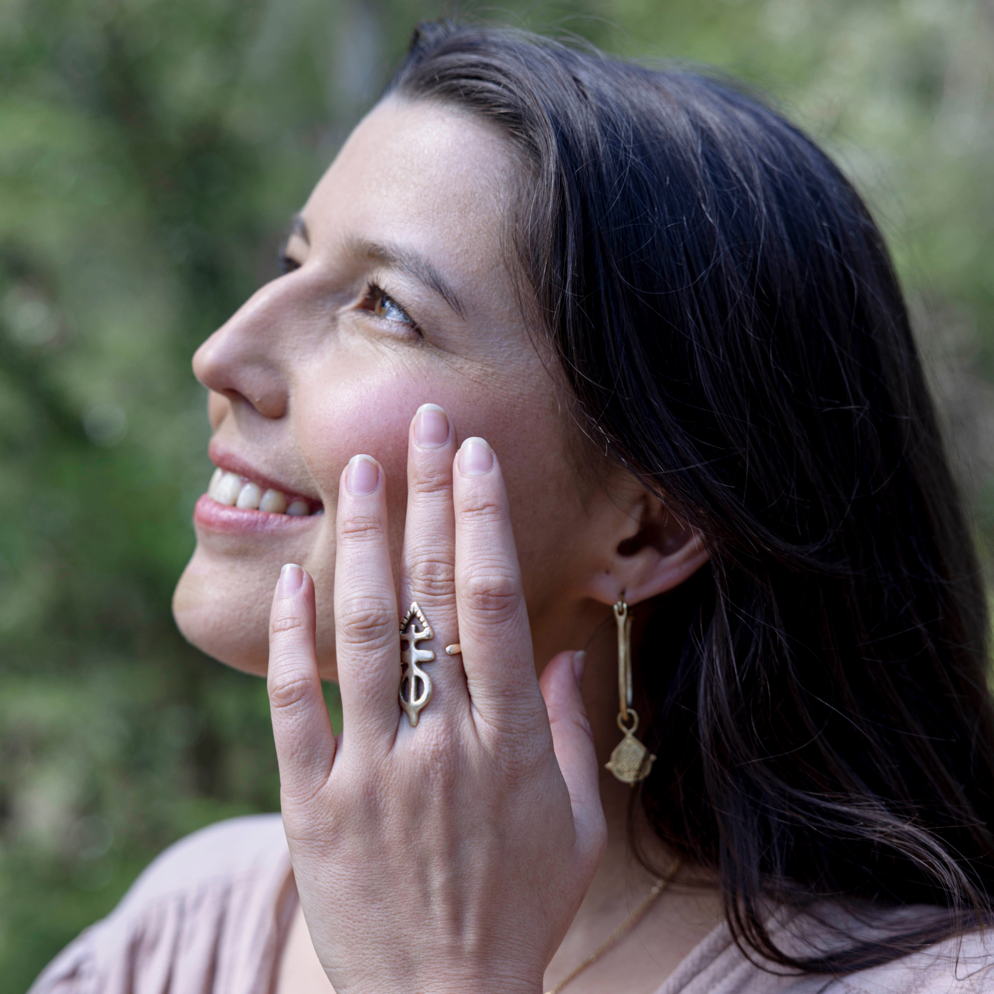 Model using blush tinted cheek and lip creme